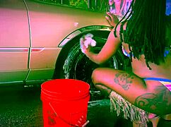 Ebony stripper performs bikini car wash in Dallas with clothes ripping