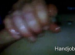 Milf gives midnight handjob leading to outdoor cumshot.