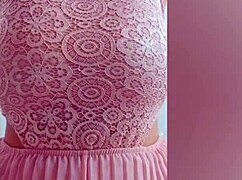 Young cutie in pink dress fingers her big natural tits on camera