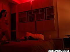 Linda Houston dances seductively under the red light with her couple