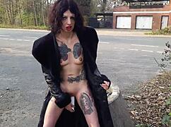 Whore shamelessly pisses and masturbates on a public street.