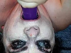 Ms. TL demonstrates throat techniques with toys and dildos in a messy setup