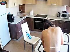 Big tits beauty cleans the kitchen topless, showing off pierced nipples.