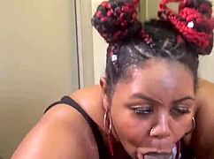 this ebony bbw is sucking a big black cock between her huge tits, so hot