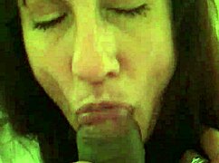 Mature white woman sucks small black cock in detailed blowjob scene.