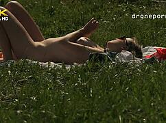 young girl with small tits masturbating on the grass, what are you doing?