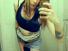 Pretty transsexual in miniskirt and stockings shows off her small cock while masturbating