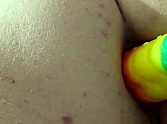 feeling the rainbow dildo slide into my ass, moaning with pleasure.