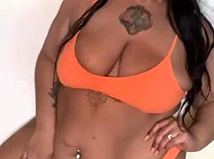 the black pornstar in bikini dances seductively, showing off her big tits and ass