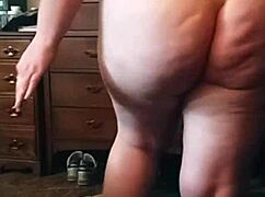 The brunette with a big sexy ass performs an enticing booty drop in the scene.