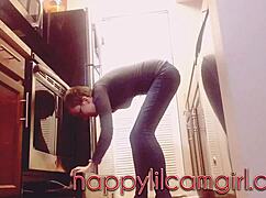 tall girl dominates kitchen cleaning while recording voyeur webcam.