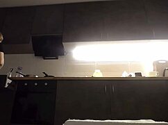 amateur woman fingers her pussy while cooking in the kitchen.