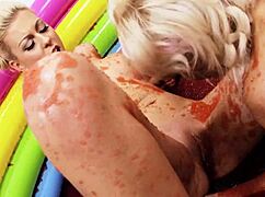 Blonde lesbians kiss and wrestle in jello-filled pool. They perform cunilingus and muff diving while finger fucking.