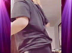 Intensely shaking booty in boyfriend's clothes during dominant dance.