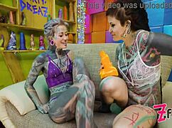 two tattooed girls get their asses fucked by a huge cock in a sloppy session