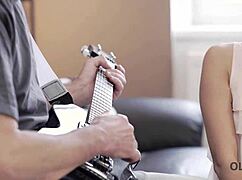 Old guitarist lets young fan play with his big instrument, daddy style.