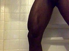 He strokes his monster black cock in the homemade shower solo.