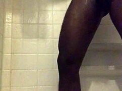 He strokes his monster black cock in the homemade shower solo.