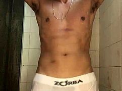 Young guy with thick cock strokes off in steamy shower bath