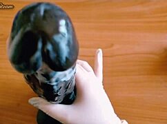 teasing handjob on huge black dildo using sexy gloves